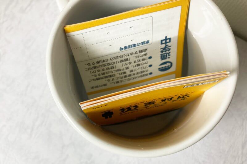 水を張ったマグカップに災害対応マニュアルを入れた画像