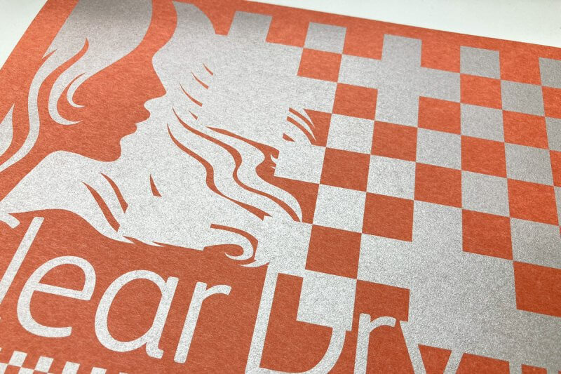 オレンジ色の紙にシルバートナーをプリントしたサンプルの画像